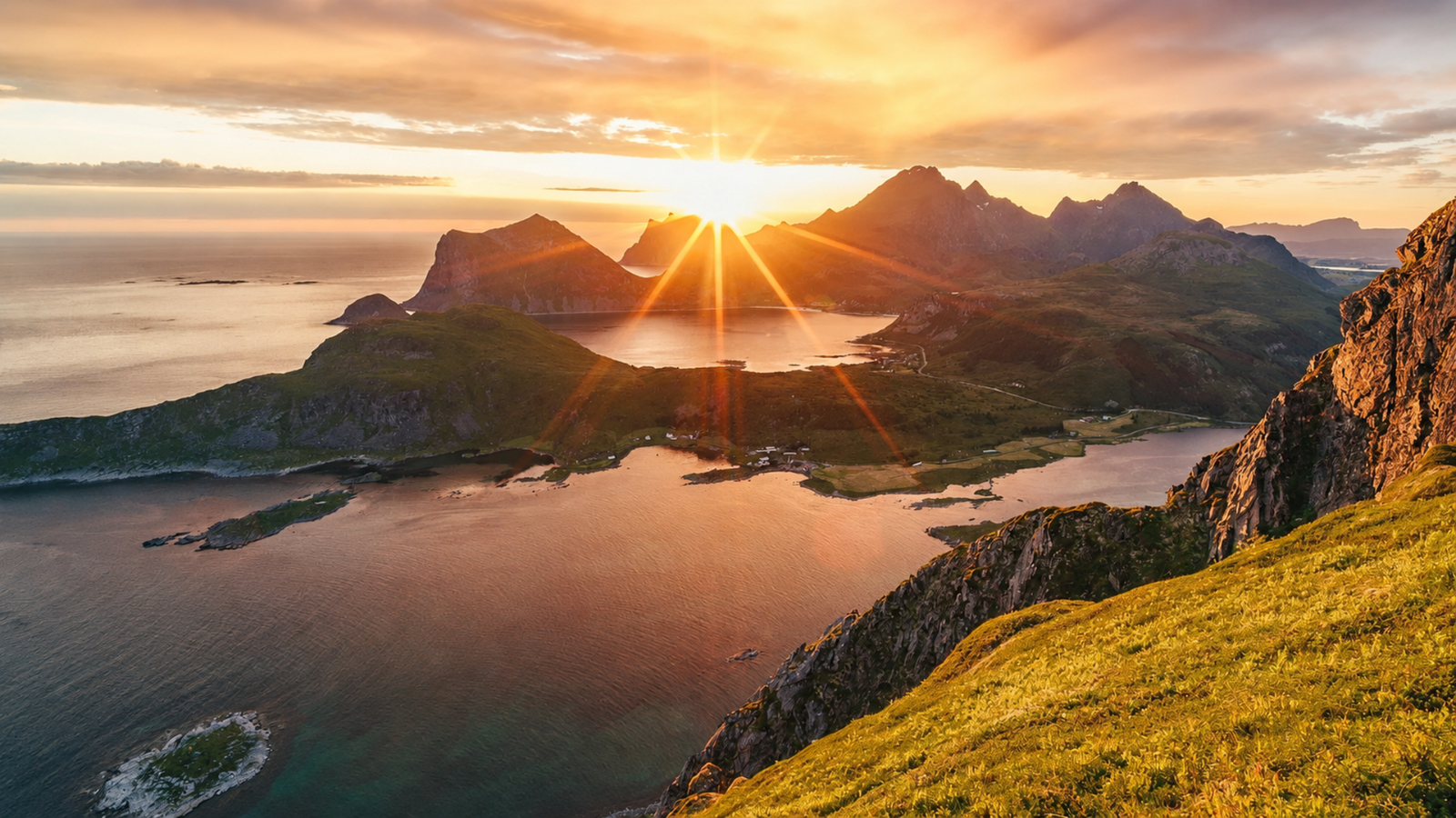 Sunset over a fjord with mountains, lake, and coastline